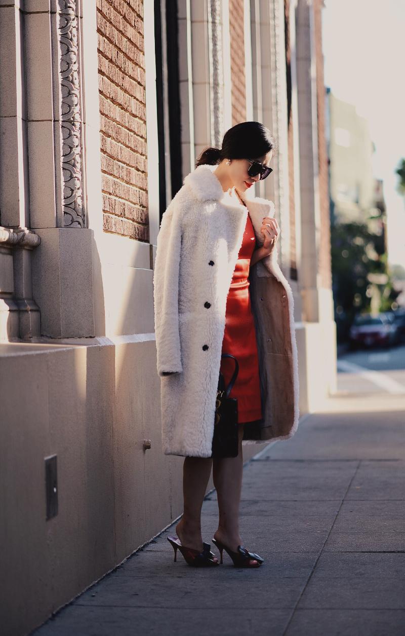 Holiday Dressing in Red Dress with Bow , Shearling Coat, via: HallieDaily