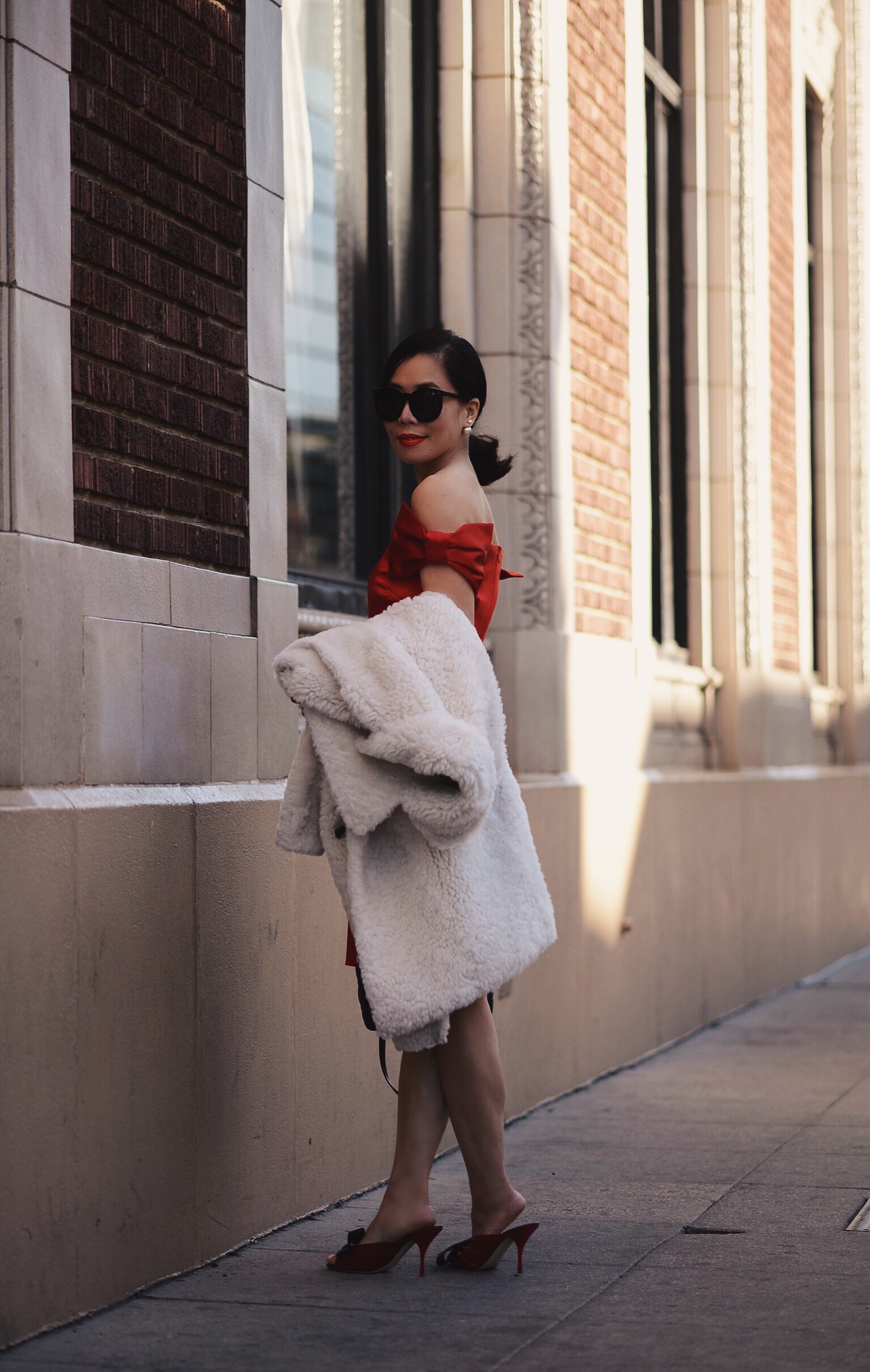 Holiday Dressing in Red Dress with Bow , Shearling Coat, via: HallieDaily