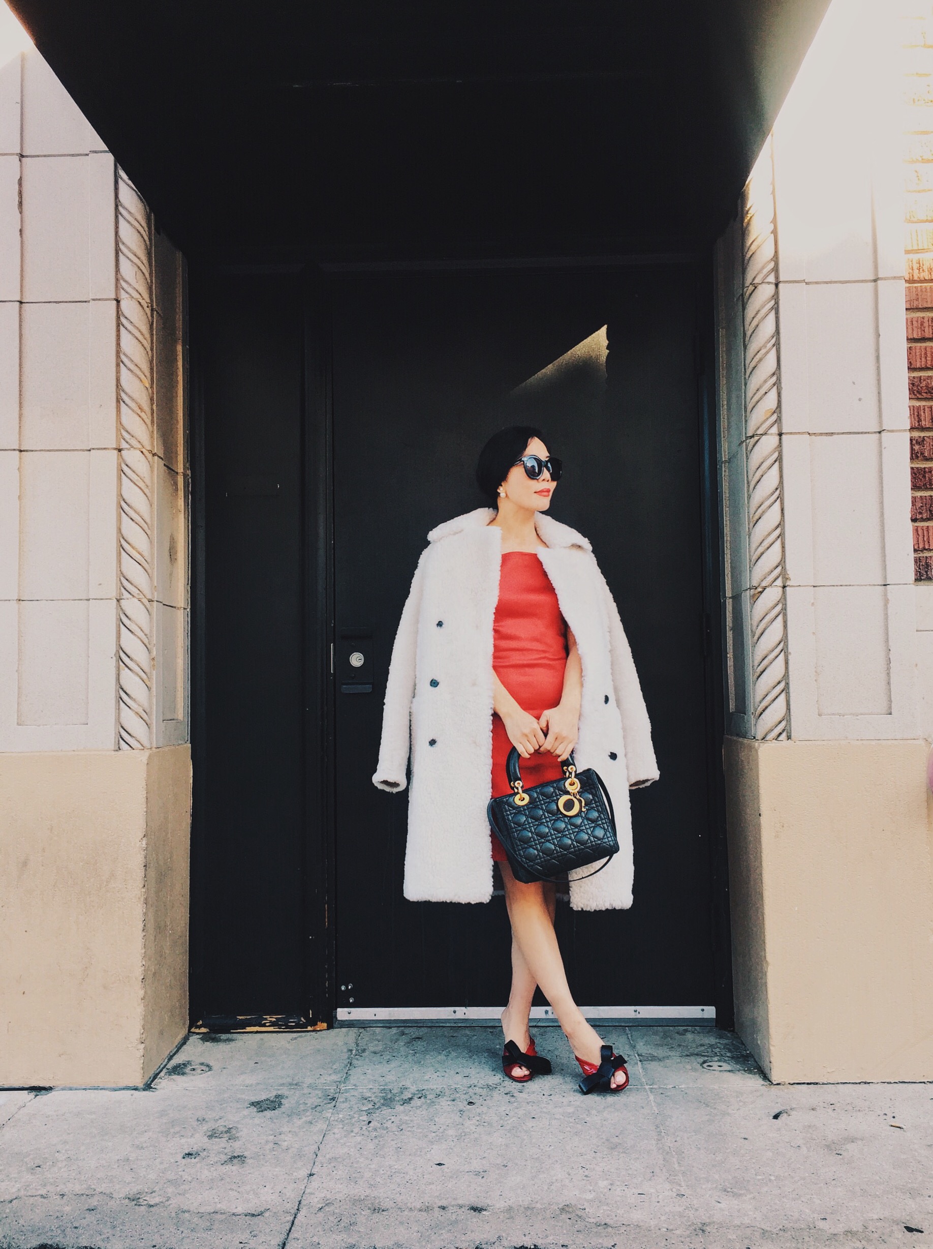 Holiday Dressing in Red Dress with Bow , Shearling Coat, via: HallieDaily