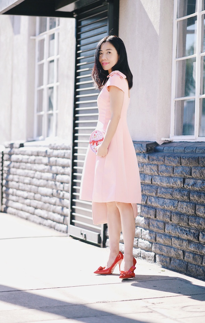 Pink & Red For Valentine's Day, Flowers, GODIVA Chocolate, Teri Jon by Rickie Freeman Pink Dress with Bow, Miu Miu Bow Pumps, Prada Bag, via: HallieDaily