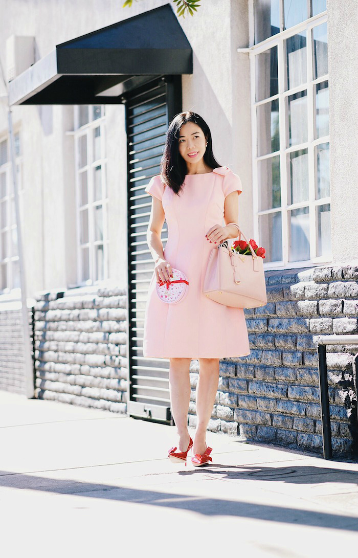 Pink & Red For Valentine's Day, Flowers, GODIVA Chocolate, Teri Jon by Rickie Freeman Pink Dress with Bow, Miu Miu Bow Pumps, Prada Bag, via: HallieDaily