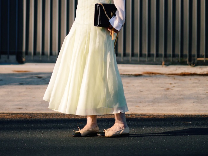 Sunset: Tibi Pleated Skirt, Chanel Two-tone Flats, YSL Bag, via: HallieDaily