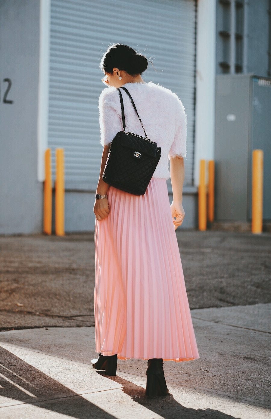 In Pink: Carven Pink Sweater, Pink Pleated Skirt, Chanel Backpack, Ankle Boots, via: HallieDaily