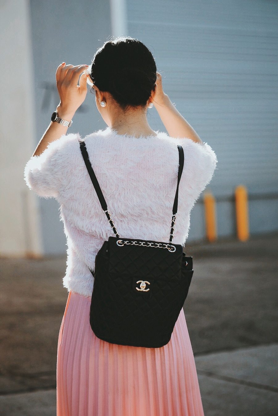 In Pink: Carven Pink Sweater, Pink Pleated Skirt, Chanel Backpack, Ankle Boots, via: HallieDaily